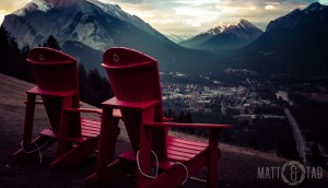 Two red chairs side by side at the top of the Mt. Norquay viewpoint